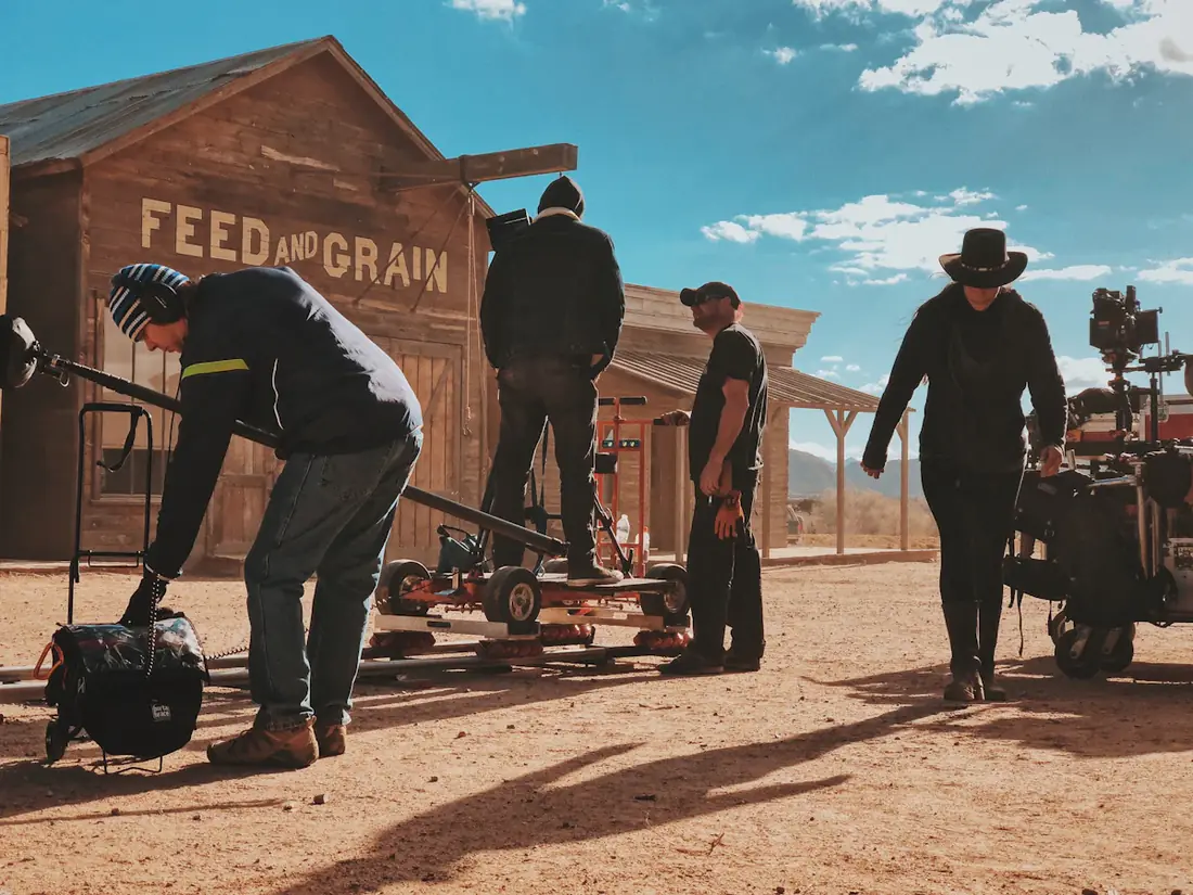 Crew moving equipment on a western town backlot